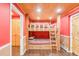 Red bedroom showcasing a unique bunk bed design with natural wood trim and ceiling at 105 S High St # A, Breckenridge, CO 80424