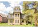 Quaint yellow home with a distinctive roofline, lush yard, and a classic architectural style at 105 S High St # A, Breckenridge, CO 80424