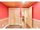 Hallway featuring a natural wood ceiling and doors leading to other areas of the house at 105 S High St # A, Breckenridge, CO 80424