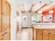 Bright hallway with wooden floors, exposed ceiling beams, and an open view to the dining area at 105 S High St # A, Breckenridge, CO 80424