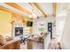 Bright living room with a stone fireplace, wood beams, and ample seating at 105 S High St # A, Breckenridge, CO 80424