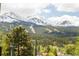 Scenic mountain view with snowy peaks, green trees and ski slopes from the neighborhood at 105 S High St # A, Breckenridge, CO 80424