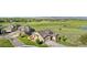 Aerial view of the home with mature trees, lush green lawns, and view of the community at 2600 Reserve Ct, Erie, CO 80516