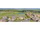 Stunning aerial view of the community, golf course, mature trees, and pond at 2600 Reserve Ct, Erie, CO 80516
