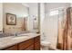 Bathroom featuring a granite countertop vanity and a shower with white tile and framed shower curtain at 2600 Reserve Ct, Erie, CO 80516