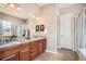 Elegant bathroom featuring dual sinks, granite countertop vanity and a large mirror at 2600 Reserve Ct, Erie, CO 80516