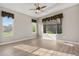 Bright bedroom with a ceiling fan, hardwood floors, and large windows with neighborhood views at 2600 Reserve Ct, Erie, CO 80516