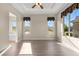 Bright bedroom with a ceiling fan, hardwood floors, and large windows with neighborhood views at 2600 Reserve Ct, Erie, CO 80516
