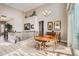 Elegant dining room featuring high ceilings, a chandelier, and natural light from the windows at 2600 Reserve Ct, Erie, CO 80516