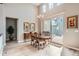 Elegant dining room featuring high ceilings, a chandelier, and sliding glass doors to the patio at 2600 Reserve Ct, Erie, CO 80516