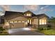 Beautiful front exterior with a two-car garage, inviting entrance, and manicured landscaping at 2600 Reserve Ct, Erie, CO 80516