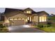 Beautiful front exterior with a two-car garage, inviting entrance, and manicured landscaping at 2600 Reserve Ct, Erie, CO 80516