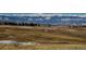 Scenic golf course landscape with snow-dusted ground and mountain range in the distance at 2600 Reserve Ct, Erie, CO 80516