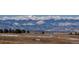 Scenic golf course landscape with snow-dusted ground and mountain range in the distance at 2600 Reserve Ct, Erie, CO 80516
