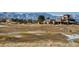 Picturesque golf course view with clubhouse and snow-capped mountains in the background at 2600 Reserve Ct, Erie, CO 80516