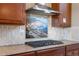 Well-appointed kitchen features granite counters, custom backsplash, and a modern range hood for stylish cooking at 2600 Reserve Ct, Erie, CO 80516
