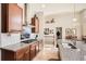 Beautiful kitchen features granite countertops, stainless steel vent hood, and views of the dining area at 2600 Reserve Ct, Erie, CO 80516