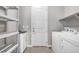 Functional laundry room featuring storage shelves, a sink, and a modern washer and dryer at 2600 Reserve Ct, Erie, CO 80516