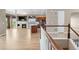 Open-concept living space with hardwood floors, stone fireplace, and seamless flow from kitchen to living area at 2600 Reserve Ct, Erie, CO 80516