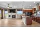 Bright, open-concept living space with fireplace, modern kitchen, and expansive windows overlooking scenic views at 2600 Reserve Ct, Erie, CO 80516