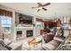 Cozy living room showcases a fireplace, hardwood floors, a ceiling fan and an open concept at 2600 Reserve Ct, Erie, CO 80516
