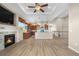 Inviting open-concept design with a cozy fireplace, modern kitchen, and staircase leading to upper level at 2600 Reserve Ct, Erie, CO 80516