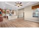 Spacious and airy open floor plan with a well-equipped kitchen, large windows, and a staircase nearby at 2600 Reserve Ct, Erie, CO 80516