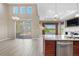 Bright living room with hardwood floors, a stone fireplace, and access to the kitchen and patio at 2600 Reserve Ct, Erie, CO 80516