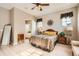 Cozy primary bedroom with hardwood floors, ensuite bathroom and a large window with natural light at 2600 Reserve Ct, Erie, CO 80516