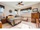 Comfortable bedroom featuring tray ceilings, hardwood floors, good natural light and ample space at 2600 Reserve Ct, Erie, CO 80516
