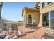 Back patio with brick flooring and black wrought iron seating overlooking the open field at 2600 Reserve Ct, Erie, CO 80516