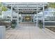 Inviting building entrance with tiled walkway, large potted plants, and a modern canopy at 3100 E Cherry Creek South Dr # 303, Denver, CO 80209
