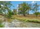 Scenic view of the building exterior near a flowing river and lush greenery at 3100 E Cherry Creek South Dr # 303, Denver, CO 80209