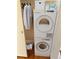 Stackable washer and dryer in a closet with additional storage at 3100 E Cherry Creek South Dr # 303, Denver, CO 80209