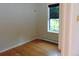 Comfortable bedroom with hardwood floors, natural light from window, and baseboard heater at 1405 Broadway St # 302, Boulder, CO 80302