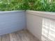 Enclosed deck with wood floors and a view of lush greenery and trees at 1405 Broadway St # 302, Boulder, CO 80302