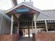 Exterior entrance showcasing a covered carport with brick and a blue address sign at 1405 Broadway St # 302, Boulder, CO 80302