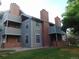 Exterior of a multi-story townhouse featuring brick accents and a well-maintained lawn at 1405 Broadway St # 302, Boulder, CO 80302