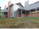 Exterior view of a home featuring gray siding, brick accents, covered entrance and sloped yard at 1405 Broadway St # 302, Boulder, CO 80302