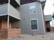 Exterior view of a multi-level home with brick and siding details and an outdoor patio at 1405 Broadway St # 302, Boulder, CO 80302