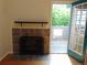 Inviting fireplace with tile surround and wooden mantel, next to a door opening to an outdoor deck at 1405 Broadway St # 302, Boulder, CO 80302