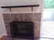 Cozy fireplace with decorative tile surround and a rustic wooden mantel, next to door to deck at 1405 Broadway St # 302, Boulder, CO 80302