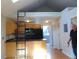 Bright kitchen featuring modern appliances, cabinets, and a ladder to a loft space at 1405 Broadway St # 302, Boulder, CO 80302