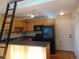 Well-lit kitchen with modern appliances, cabinets, a breakfast bar and a ladder to a loft space at 1405 Broadway St # 302, Boulder, CO 80302