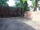 Designated parking area featuring a wooden fence and a brick wall at 1405 Broadway St # 302, Boulder, CO 80302