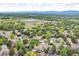 Gorgeous aerial view of suburban neighborhood with mature trees and a community lake at 1665 W 113Th Ave, Denver, CO 80234