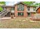 Backyard featuring well-maintained brickwork, a lawn and a two-story brick house at 1665 W 113Th Ave, Denver, CO 80234