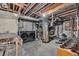 Unfinished basement features laundry area, water heater, and exposed pipes at 1665 W 113Th Ave, Denver, CO 80234