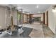 Finished basement featuring exercise equipment, a stone fireplace, carpeted floors, and outdoor access at 1665 W 113Th Ave, Denver, CO 80234