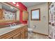 Bathroom with a wooden vanity, granite countertop, custom mirror, and a shower/tub combination at 1665 W 113Th Ave, Denver, CO 80234